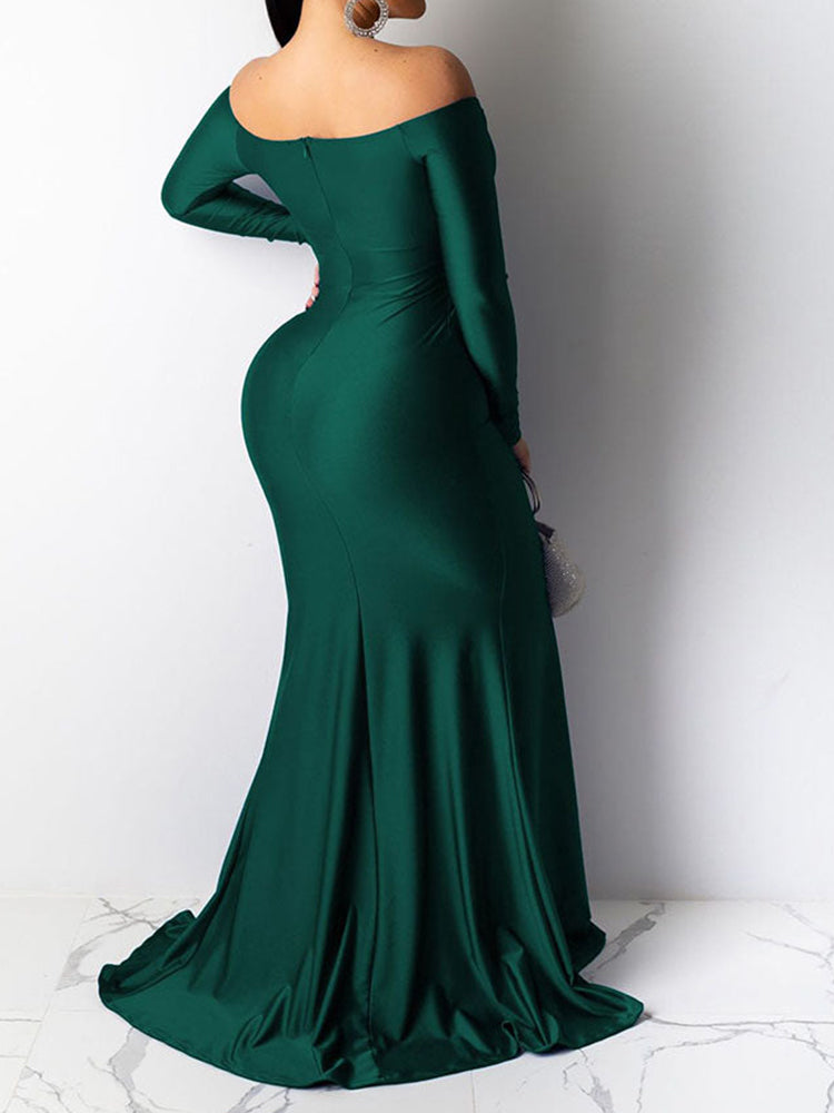 Back view of a woman in a green off-the-shoulder long-sleeved mermaid gown with a high slit