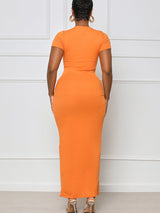 Woman wearing an orange ribbed knit maxi dress with a high slit and drawstring detail, shown from the back