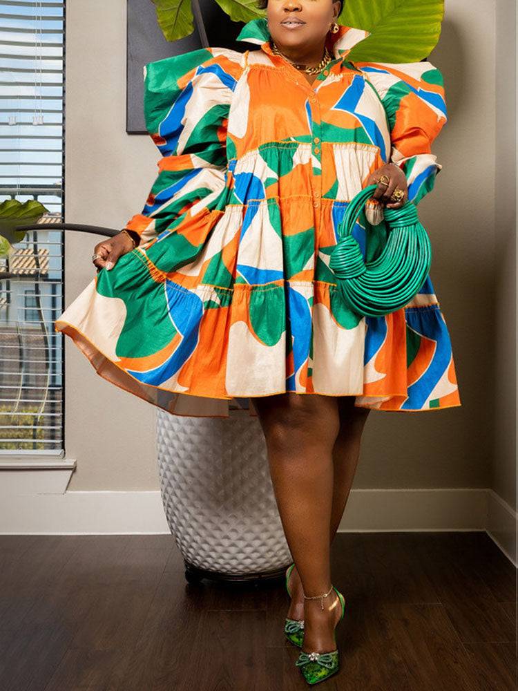Woman wearing a colorful, abstract print mini dress with puffed sleeves and a tiered skirt.