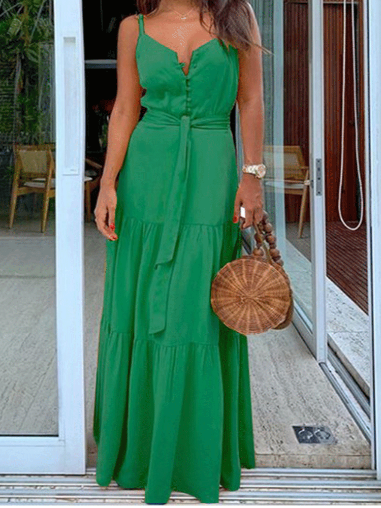 Woman wearing a green maxi dress with spaghetti straps, V-neck, button-down front, and tiered skirt.