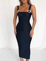 Full body shot of a woman in a black sheath dress with a square neckline and decorative buckle straps.