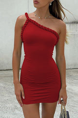 Woman in a red one-shoulder bodycon mini dress with rope detailing, wearing a necklace.