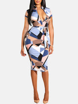 Woman wearing a short-sleeved geometric print pencil dress with a belted waist and V-neckline, standing against a white background.