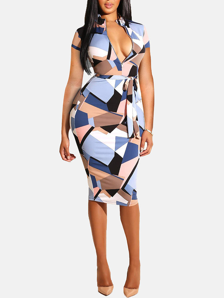 Woman wearing a short-sleeved geometric print pencil dress with a belted waist and V-neckline, standing against a white background.