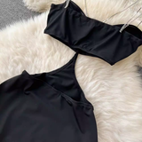 Detail of the cut-out design and halter neckline of a black maxi dress.