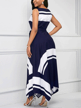 Woman wearing a navy blue and white sleeveless A-line maxi dress with a scoop neck, tie waist, and asymmetrical hemline, back view