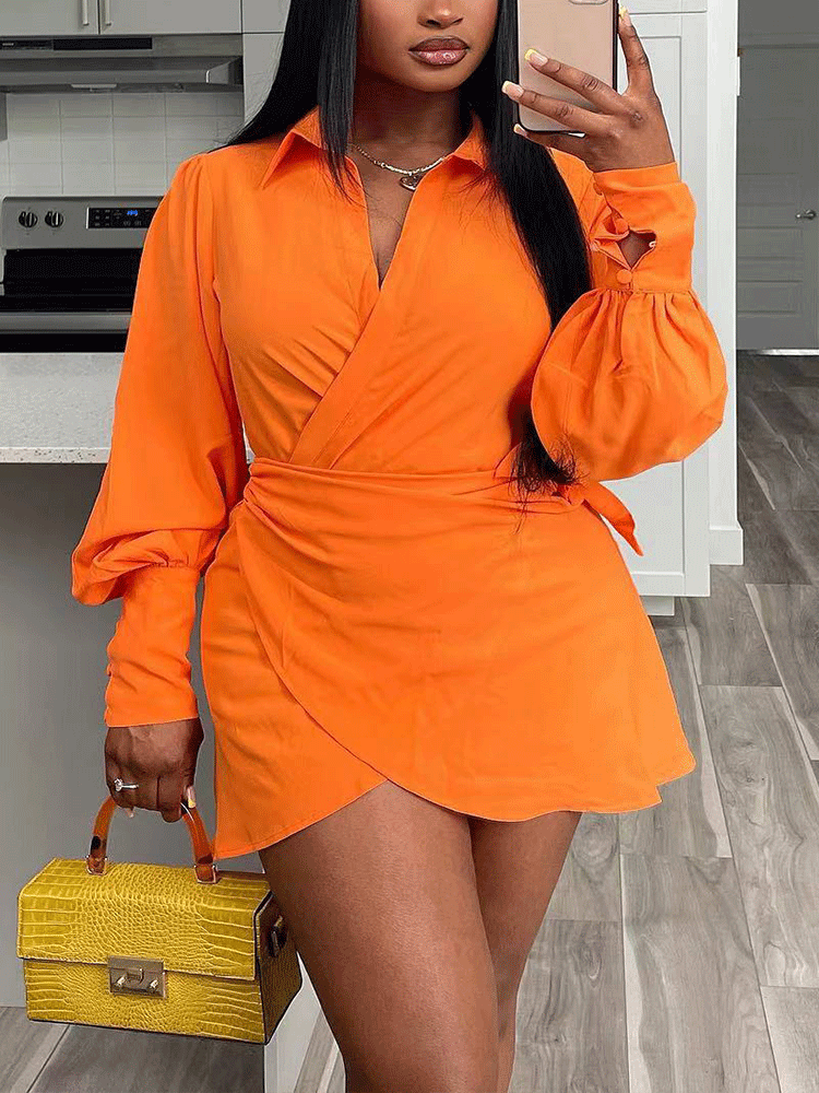 woman wearing an orange wrap dress with bishop sleeves