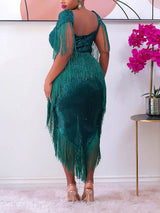 Back view of a woman in a sparkling green sequined dress with fringe.