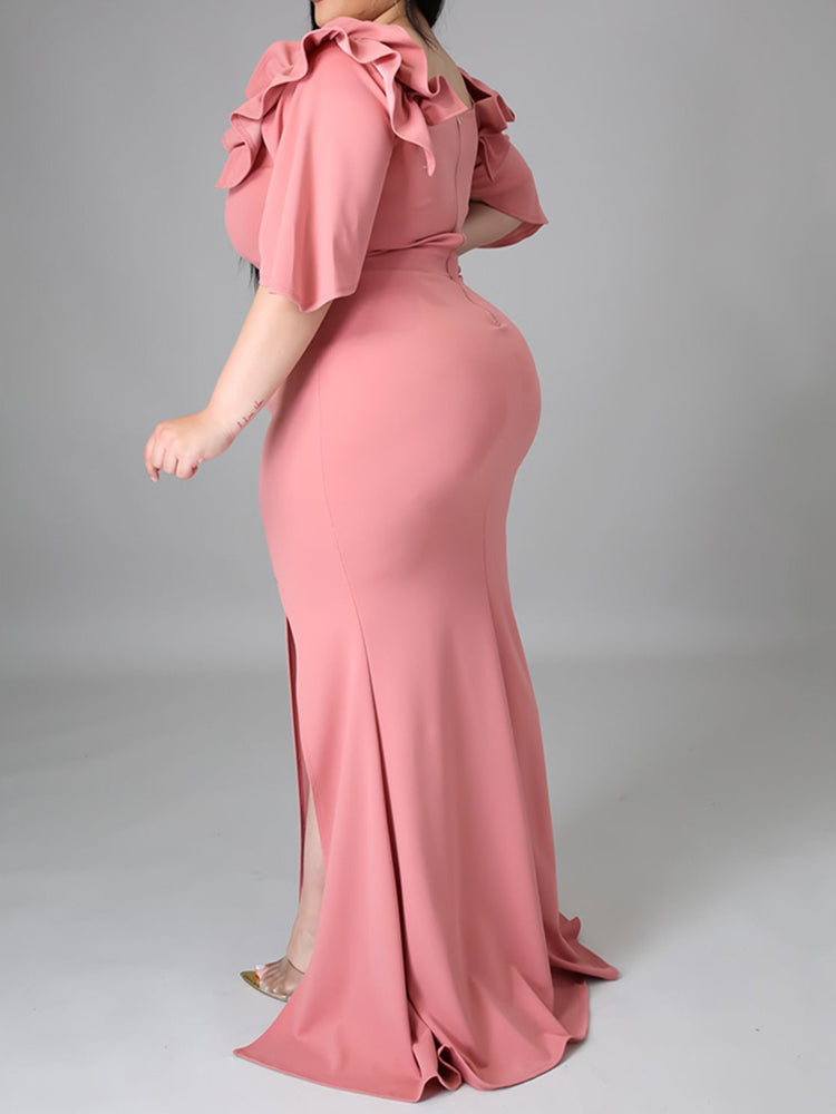 Back view of a woman in a pink evening gown with a zipper closure