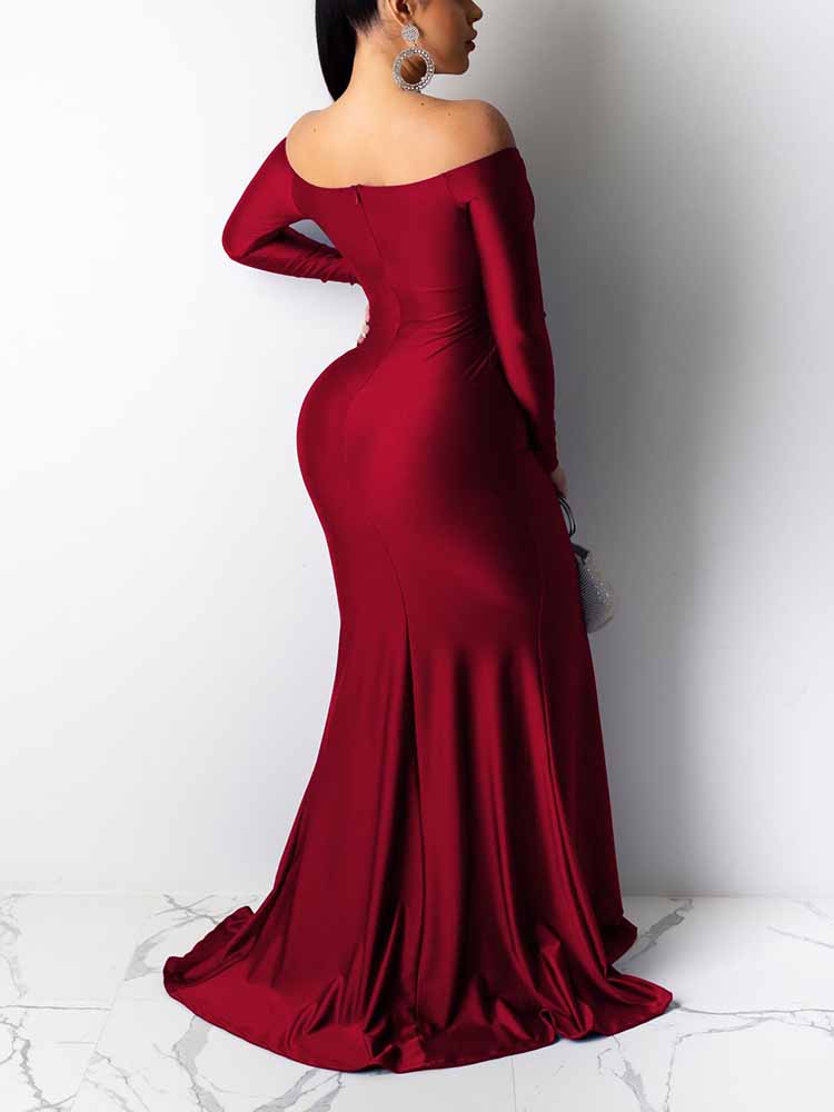 Back view of a woman wearing a long, red, off-the-shoulder satin gown with a high slit and mermaid hemline.