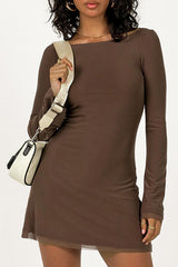 Woman wearing a brown long sleeve mini dress with bell sleeves and a sheer hem, carrying a crossbody bag.