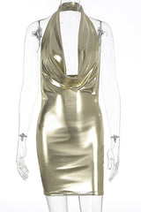 Mannequin displaying a gold metallic halter neck dress with a cowl neckline and a fitted silhouette.