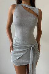 close-up of a woman wearing a silver metallic knit asymmetrical neckline mini dress with a cut-out detail and ruched skirt