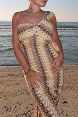 Close-up of the patterned knit dress worn by a woman on the beach.