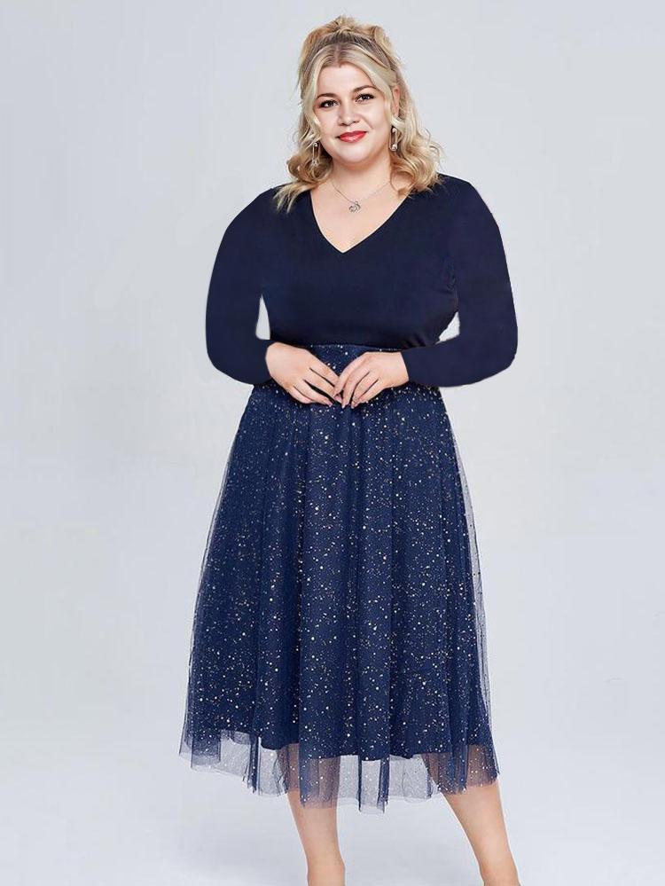 Plus size model wearing a navy v-neck long sleeve sparkle midi dress
