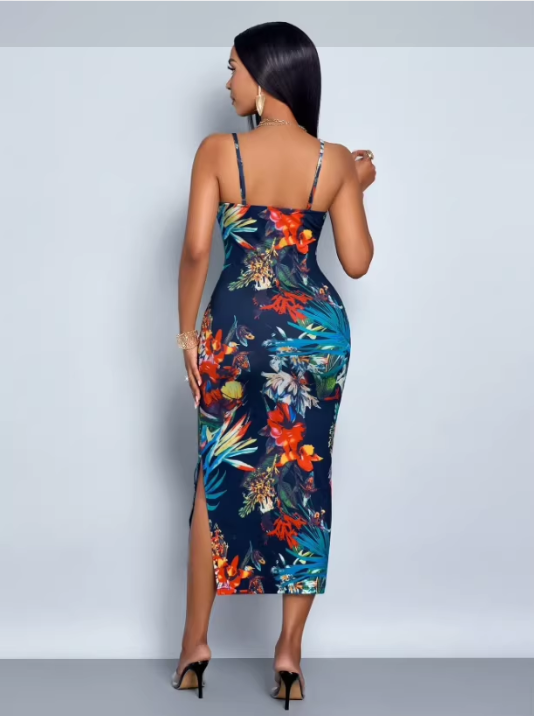 Back view of a woman in a navy blue floral print bodycon midi dress with spaghetti straps and a side slit.
