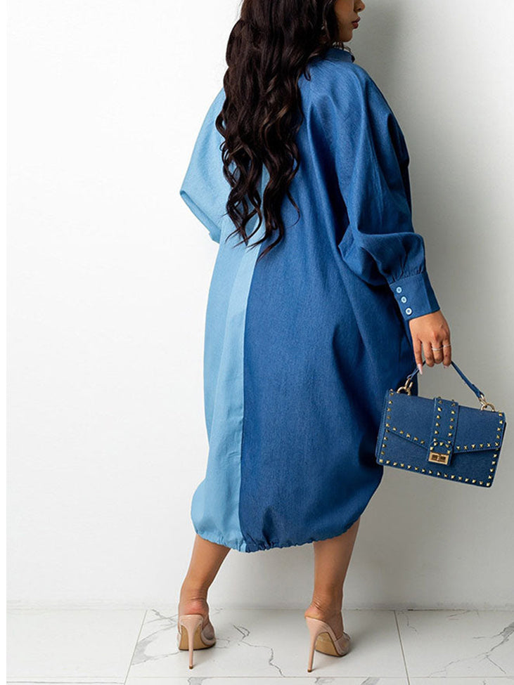Back view of a woman wearing a two-tone blue oversized shirt dress with button-down front and adjustable drawstring hem, holding a studded handbag.