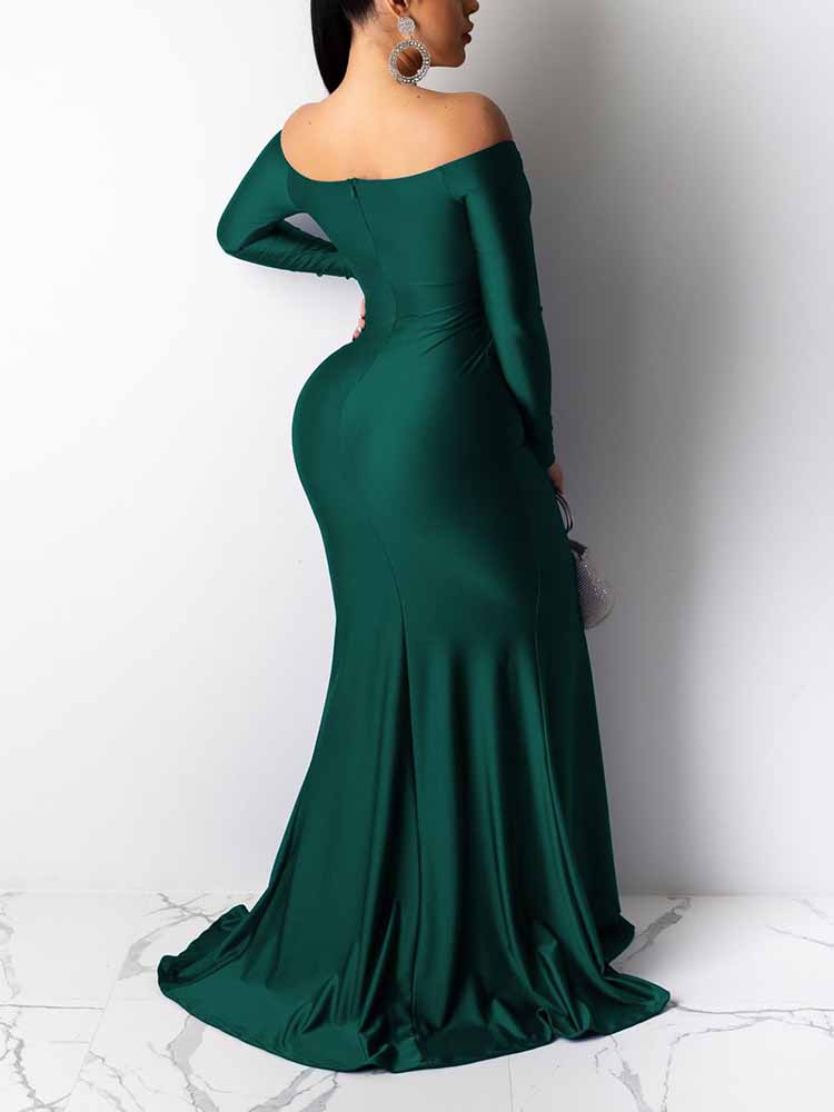 Back view of a woman wearing a long, emerald green, off-the-shoulder satin gown with a high slit and mermaid hemline.