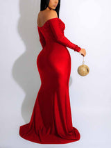 back view of a woman in a red off-the-shoulder formal gown