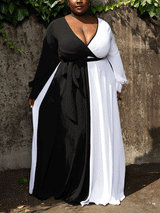 Woman wearing a black and white color-block maxi dress with long sleeves and a V-neck.