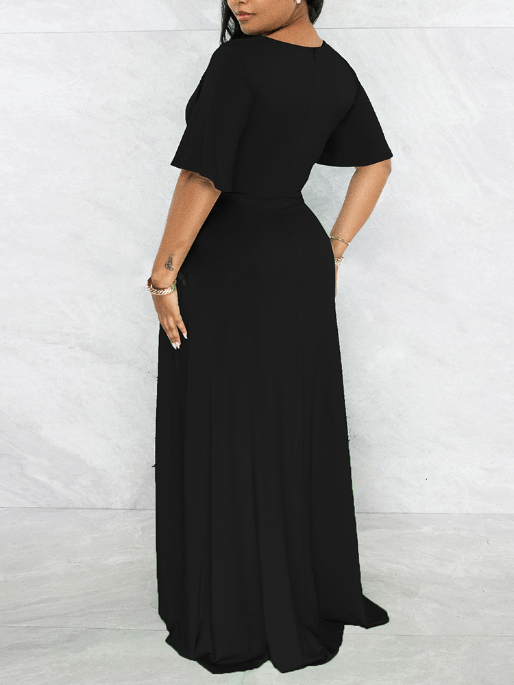 Back view of a woman in a black maxi dress with a flowing skirt