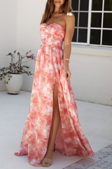 Close-up of the high slit on a strapless floral print maxi dress
