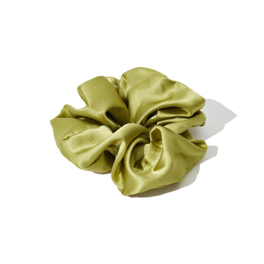 A close-up studio shot of a lime green satin scrunchie on a white background.