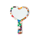front view of a heart-shaped hand mirror with a multicolored confetti acetate frame