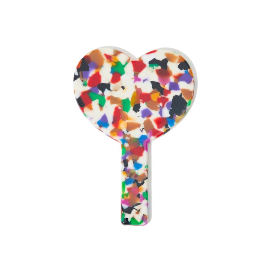 back view of a heart-shaped hand mirror with a multicolored confetti acetate frame