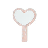 Front view of a heart-shaped hand mirror with a pink marbled handle