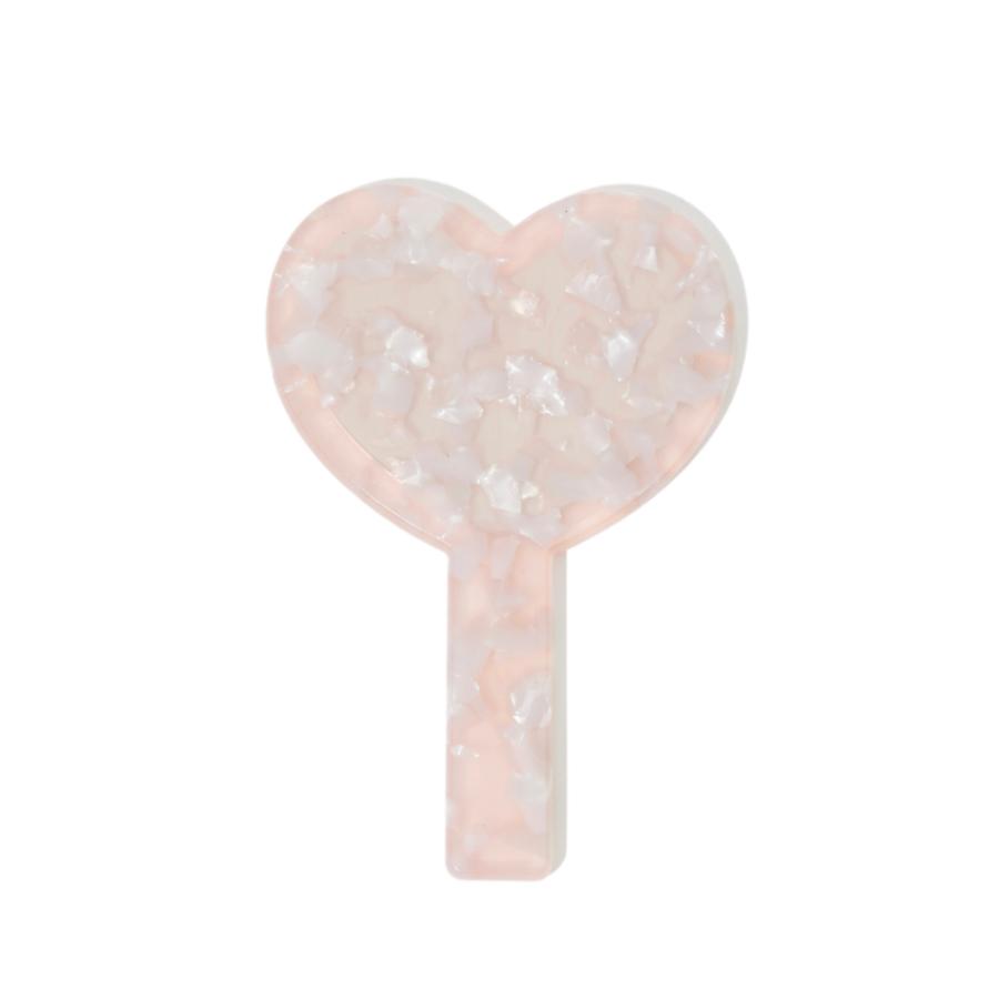 Back view of a heart-shaped hand mirror with a pink marbled handle, showing the textured pattern