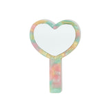 Front view of a heart-shaped handheld mirror with a marbled multicolor acetate frame and handle