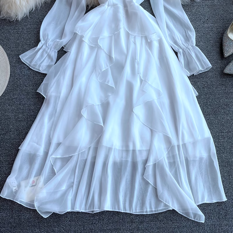 Close-up of the tiered ruffled skirt of a white dress