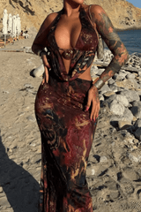 Full body shot of a woman in a printed maxi dress with a halter neckline