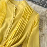 A woman wearing a chic pleated maxi dress with a tiered skirt and puff sleeves. - View 9 | Lwiis
