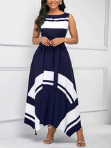 Woman wearing a navy blue and white sleeveless A-line maxi dress with a scoop neck, tie waist, and asymmetrical hemline, front view