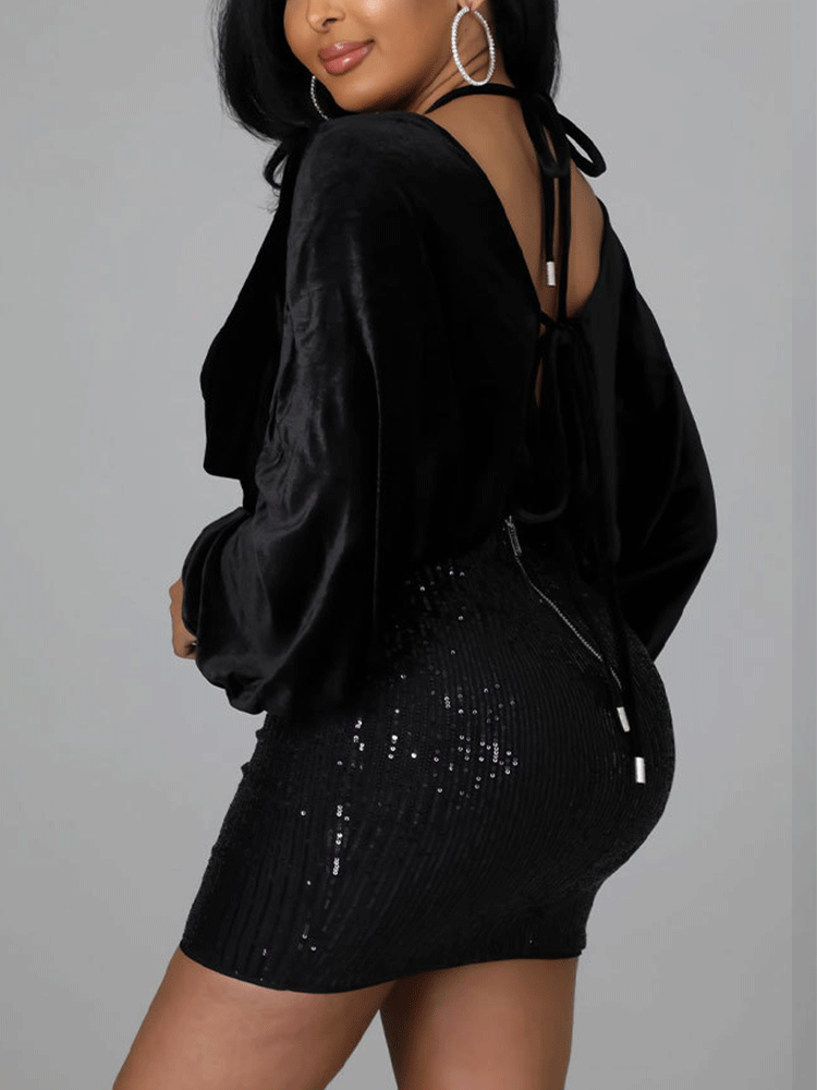 Back view of a black velvet and sequin mini dress with an open back