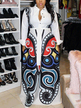 Woman wearing a white maxi dress with a large, colorful butterfly print on the skirt, standing in front of a closet filled with shoes.