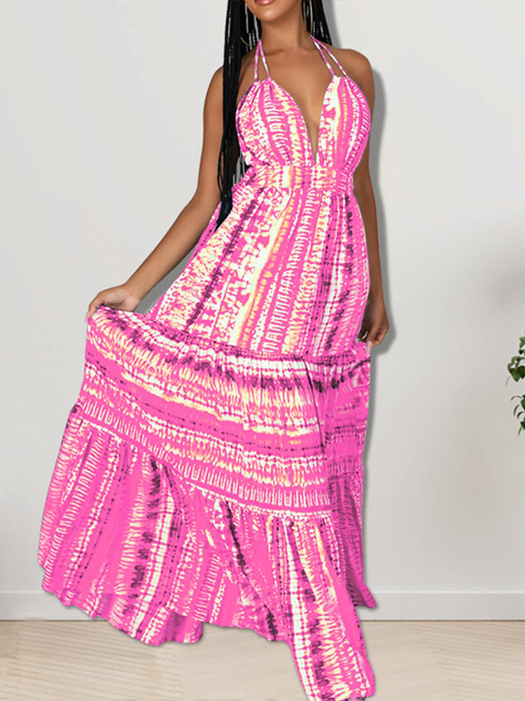 Woman posing in a long pink tie-dye halter neck dress