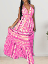 Woman posing in a long pink tie-dye halter neck dress