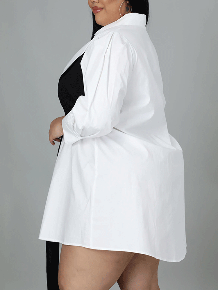 Side view of a plus-size woman in a white shirt dress with a black bow, highlighting the dress's structure and sleeve.