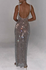 back view of a woman in a long, open-back rhinestone dress