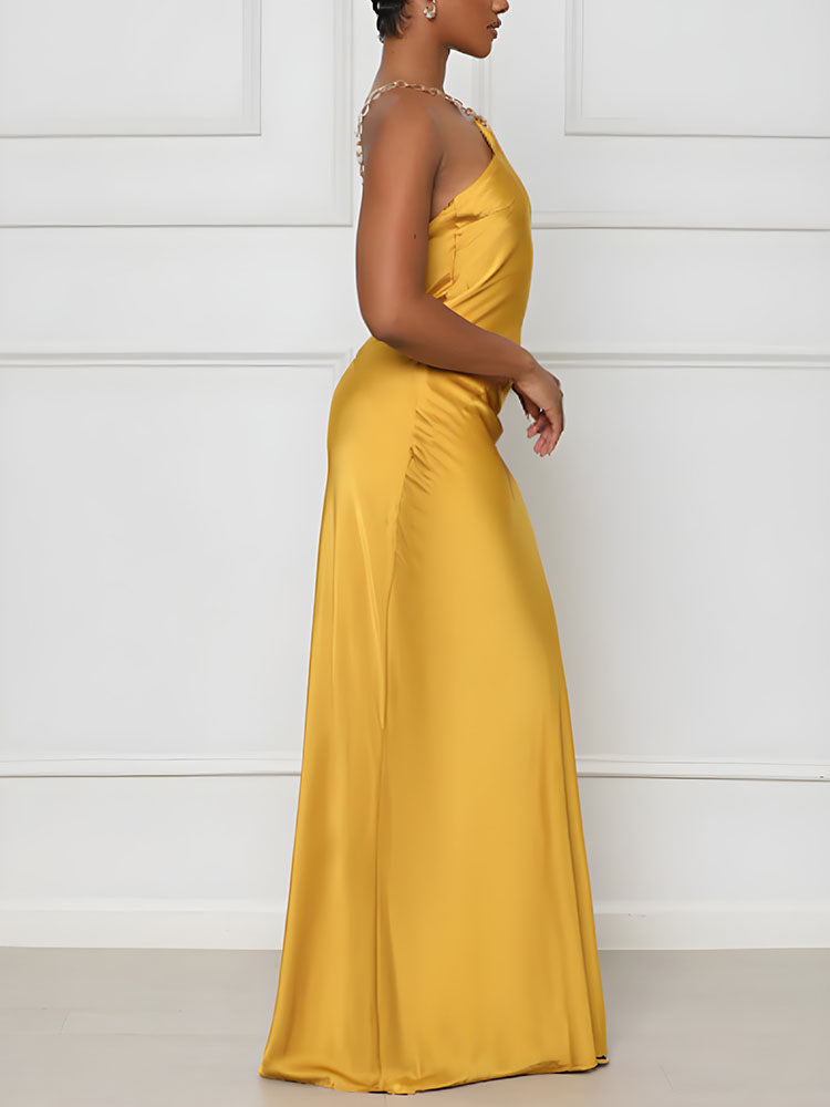 side view of a woman in a yellow satin slip dress