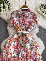 The full view of a women's floral print midi dress, showcasing its A-line silhouette and sheer fabric.