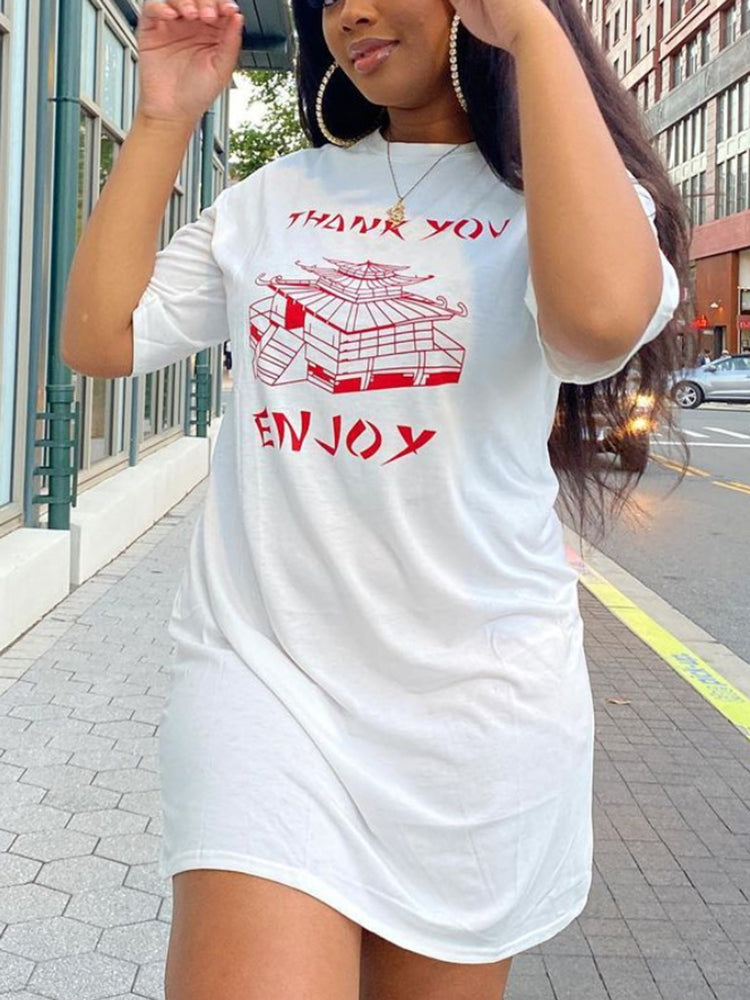 Close-up of a woman wearing a white t-shirt dress with red graphic print