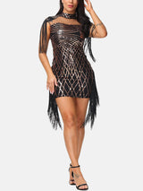 woman in a short black and gold sequin dress with fringe and a mock neck