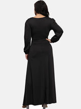 Back view of a woman in a black long-sleeved evening gown.