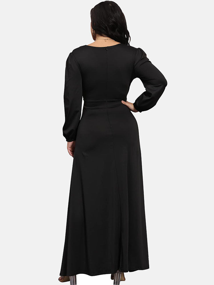 Back view of a woman in a black long-sleeved evening gown.