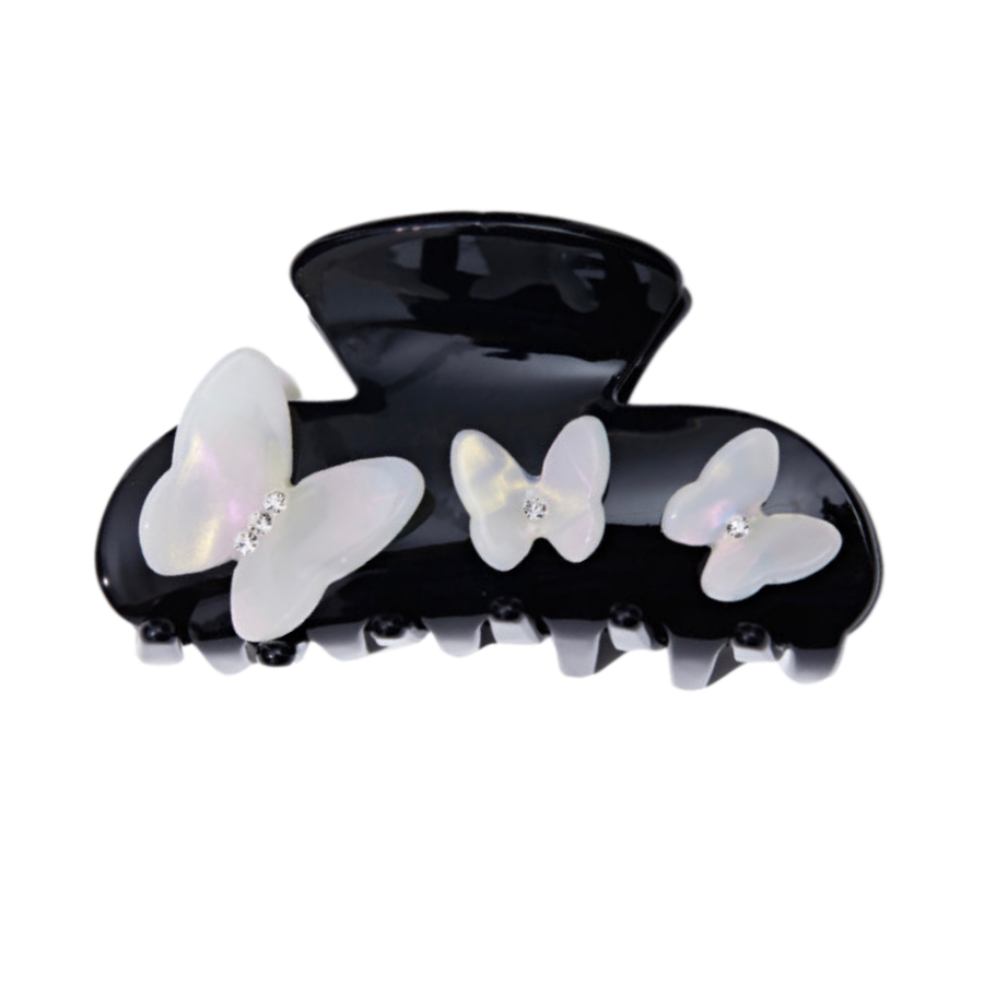 Black claw hair clip with three white iridescent butterfly embellishments, each with a small gem accent.
