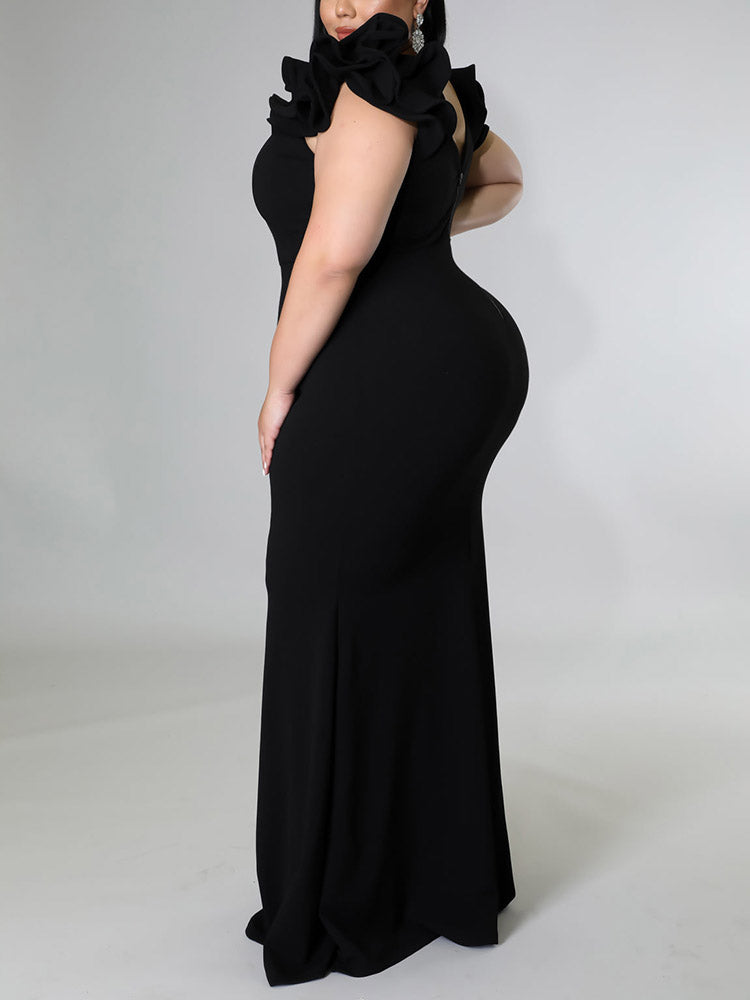 Back view of a plus-size model in a black formal gown with a v-neck and ruffled sleeves.
